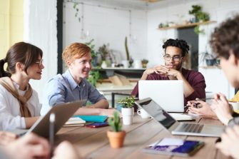 Group of workers around a desk