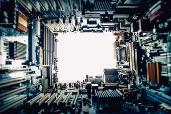 Motherboards with visible multiple logos and identifiable info (none prominent), motherboards all around, white background, copy space in the middle