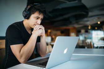 Man with headphones working on laptop