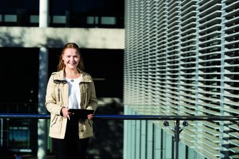 Student holding folder and pen