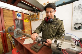 Man working with equipment at workbench