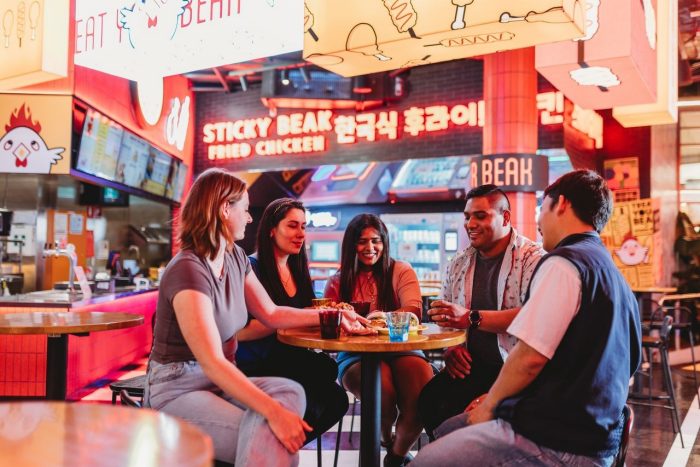 A group of students sit at Tiger Lane in Canberra Centre 