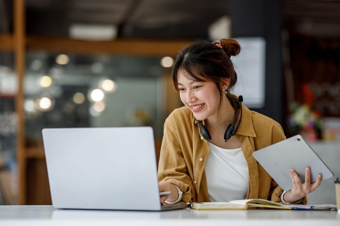 Student learning with laptop and tablet