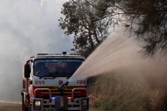 fire truck putting out bushfire
