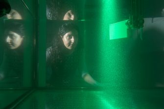 Dr Soudeh Mazharmanesh  from the University of NSW Canberra watch illuminated particles flow through a tank while testing a wing shape.