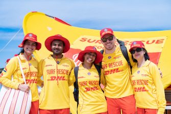 Five people wearing Surf Rescue gear, smiling at the camera.