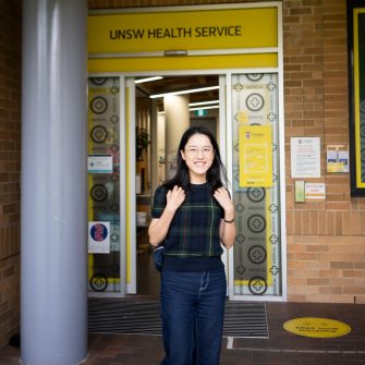 Student smilling stand outside of the UNSW Health Service
