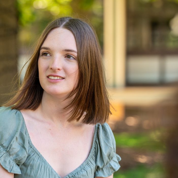 A group of students chatting while sitting on Library Lawn on Kensington Campus