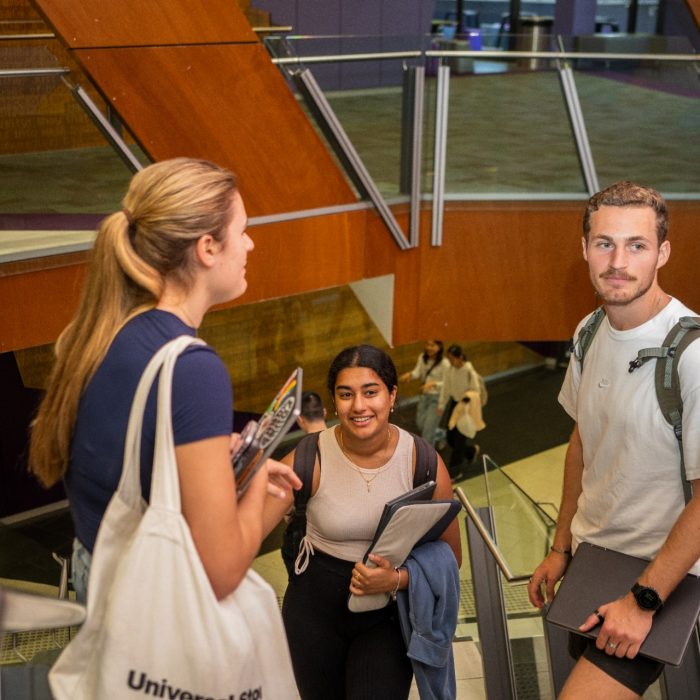 A group of students walking up stairs in the UNSW Law & Justice building