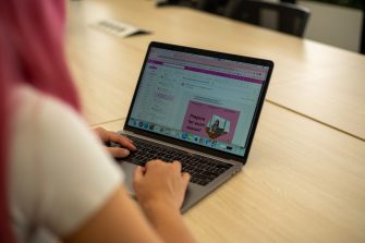 Students with their laptops in the Paddington Library