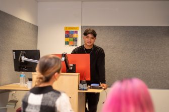 Students doing presentations in a classroom on Paddington Campus