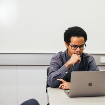 A student looking at a laptop