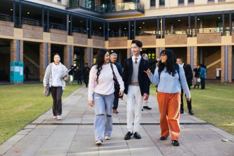 Students walking across Helen Maguire Lawn on campus