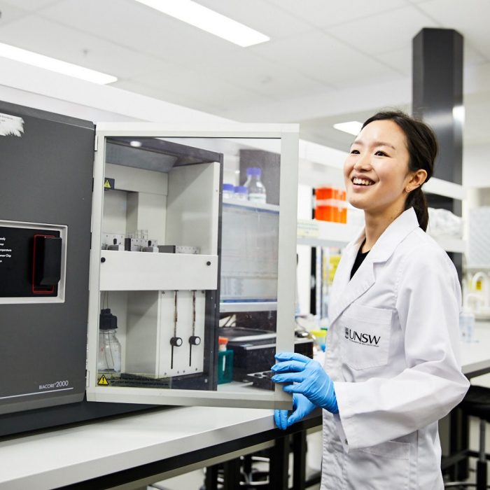 A laboratory technician working with engineering equipment