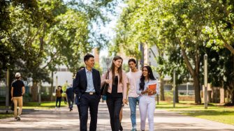 four students walking through the UNSW Kensington campus
