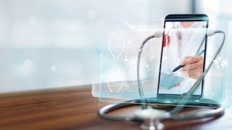 A doctor on a video call listening through a stethoscope