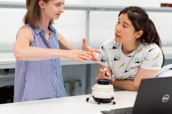 Female students collaborating on robot