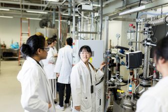 Students working on high tech lab equipment