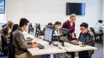 Students engaging in a hackathon at their computers in a classroom