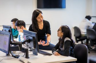 A computer science and engineering academic in discussion with a student