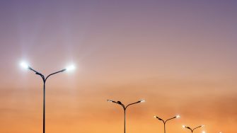 Urban landscape with modern minimal street lights and vibrant sky. Vivid city background.