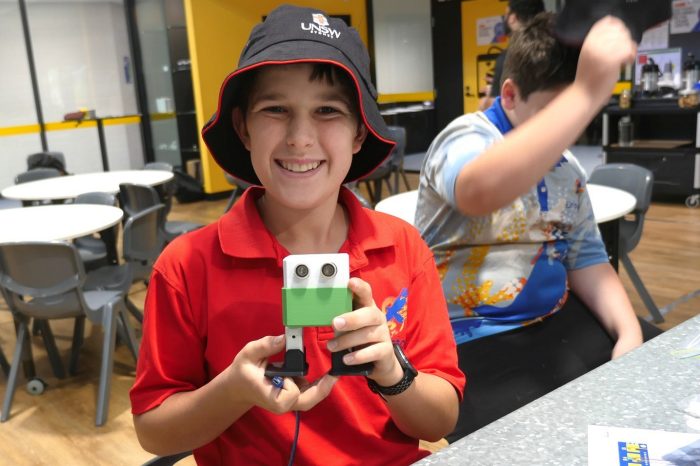 A student from Dripstone Middle School in Darwin shows off a dancing robot made with equipment from the UNSW Makerbus.