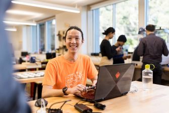 Student sitting at desk in Makerspace workshop