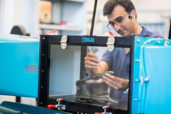 Engineer in workshop working with tools