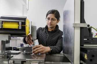 Engineering student working with machinery