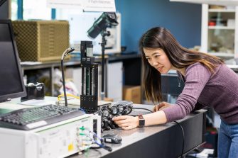 Electrical engineering postgraduate student working in lab