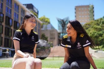 Two UNSW students sitting outdoors on campus