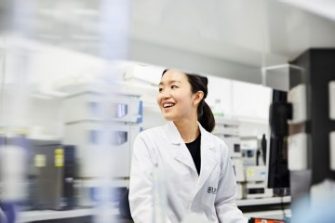 Female Lab technician smiling in lab coat
