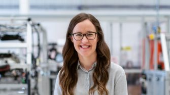 female engineer standing in worskshop landscape shot