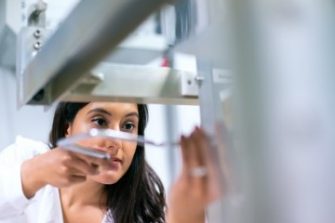 woman in lab holding object 2