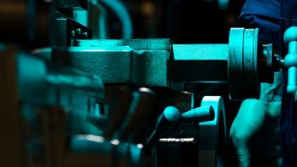 dark shot of engineer turning levers 