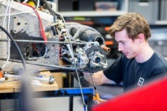 Student engineer looking at engine