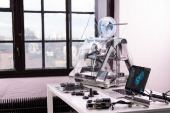 3d printer and laptop on white table