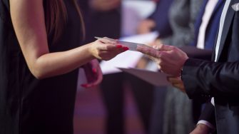 Close-up of people presenting awards