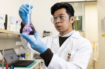 Student inspecting chemical in lab