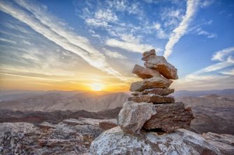A rock pile ontop of a mountain ridge