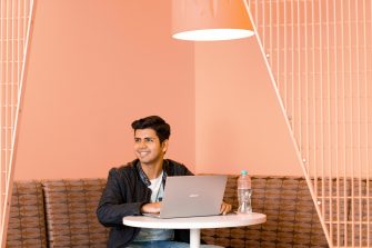 Saurabh Kaura working on his laptop during an India roadshow event