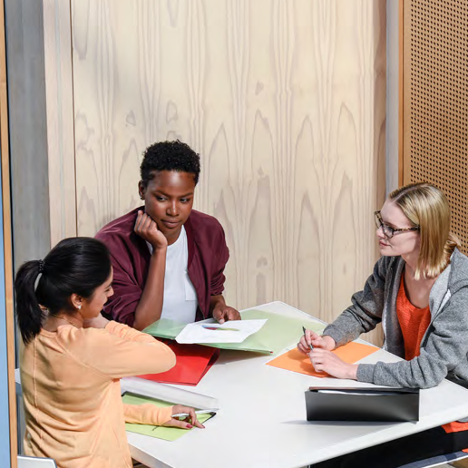 Three women have a serious discussion about their work 