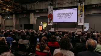 Luke McNamara presenting on stage at 2025 Sydney Writers' Festival