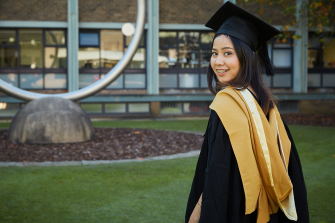 Graduating student in the library lawn
