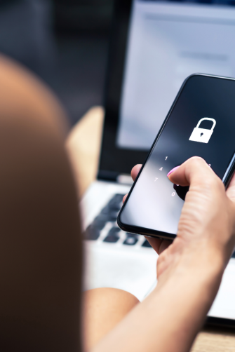 Phishing, mobile phone hacker or cyber scam concept. Password and login pass code in smartphone. Online security threat and fraud. Female scammer with cellphone and laptop. Bank account security.