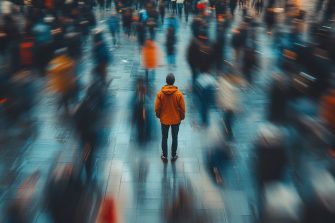 A person standing in a crowded urban environment, with blurred figures rushing by, creating a feeling of isolation and anxiety amidst chaos
