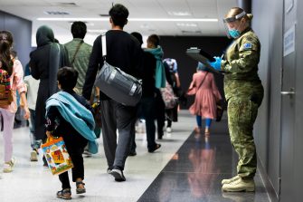 Australian Army Private Jemma Fulton assists Australian citizens and visa holders evacuated from Afghanistan off their flight into Australia. *** Local Caption *** Evacuees from Afghanistan arrived in Australia via a Royal Australian Air Force flight. The evacuation occurred as part of ongoing Non Combatant Evacuation Operations supported by the Australian Defence Force, assisting urgent government efforts to repatriate Australian citizens and visa holders in Kabul.