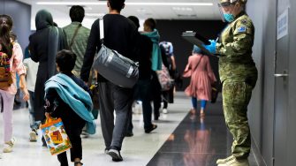 Australian Army Private Jemma Fulton assists Australian citizens and visa holders evacuated from Afghanistan off their flight into Australia. *** Local Caption *** Evacuees from Afghanistan arrived in Australia via a Royal Australian Air Force flight. The evacuation occurred as part of ongoing Non Combatant Evacuation Operations supported by the Australian Defence Force, assisting urgent government efforts to repatriate Australian citizens and visa holders in Kabul.