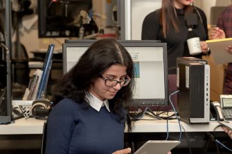 Image of two KLC Students learning in an office