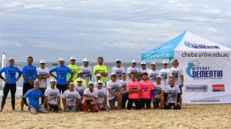 Wipeout Dementia surfing team poses on beach